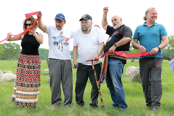 Terry Haney, president of Manitoba Métis Federation (MMF) Fort-Ellice local, Elder Lawrence Belhumeur and Will Goodon of Manitoba Métis Federation Southwest Region (MMFS) cutting the ribbon at the grand opening of the Fort Ellice site on Friday, May 26. <br />